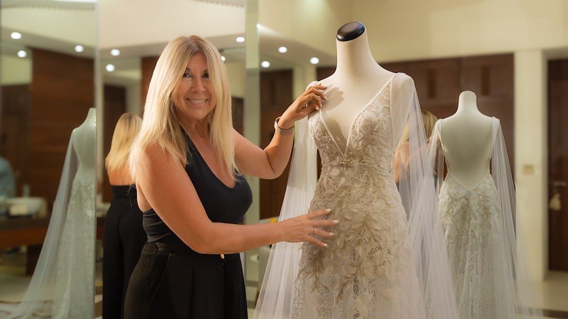 A woman standing next to a mannequin